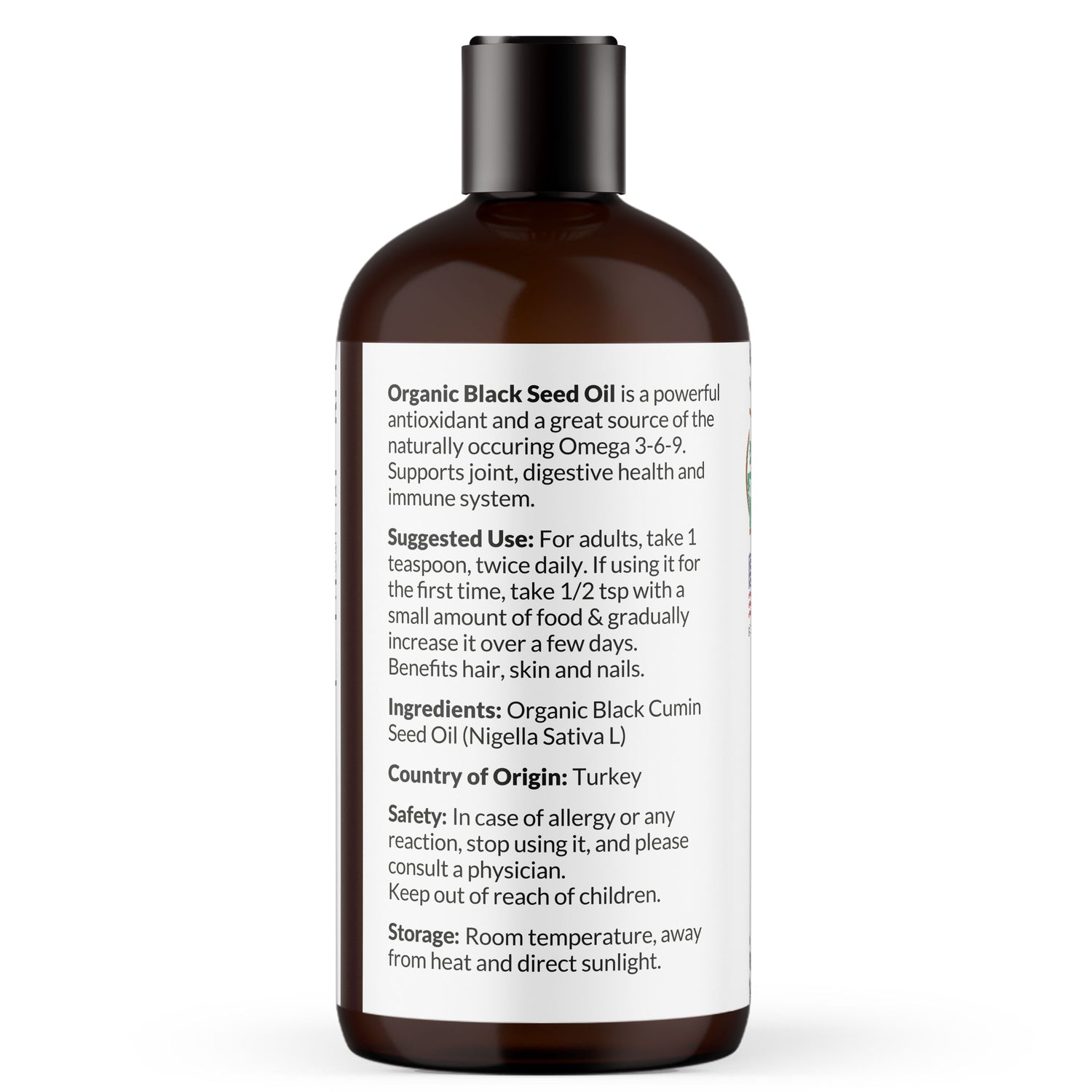 Bottle of 100% pure organic black seed essential oil with white label describing usage directions for digestive health and immune system