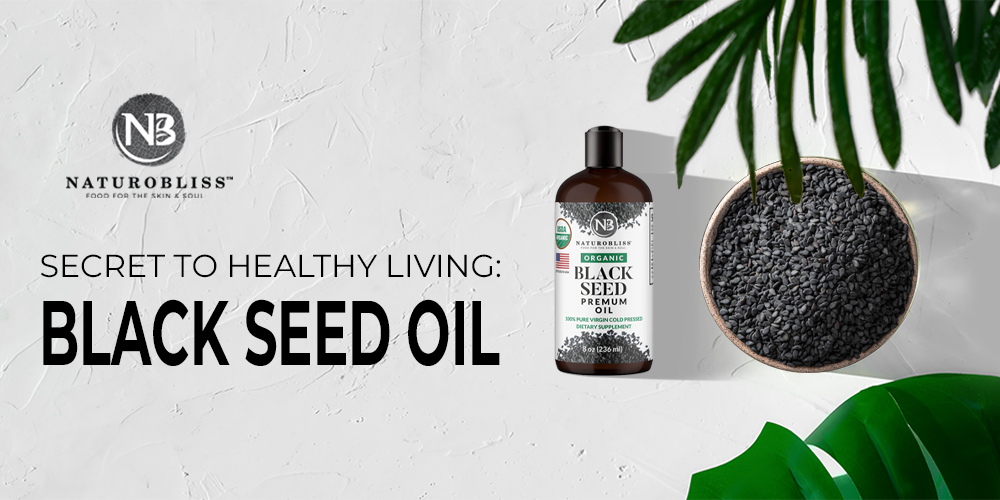 Black seed oil bottle with a bowl of blackseed nearby